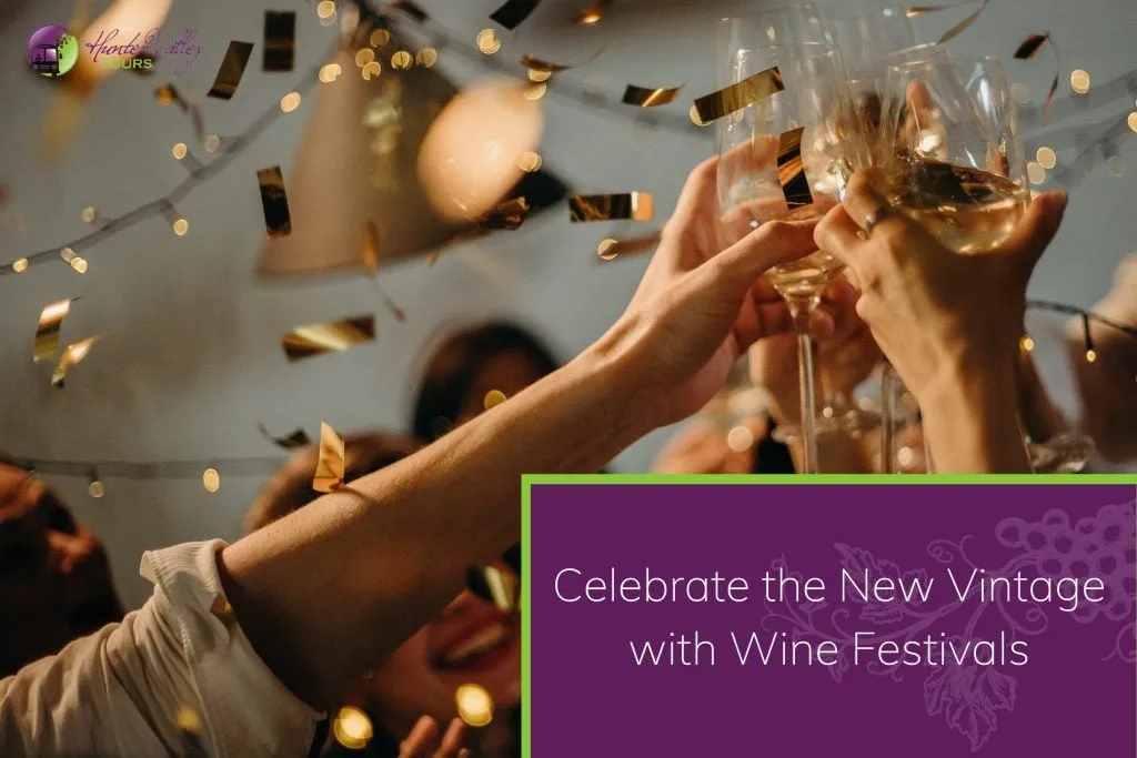 Celebratory party with people toasting with wine glasses under wine festival golden confetti and warm lighting.