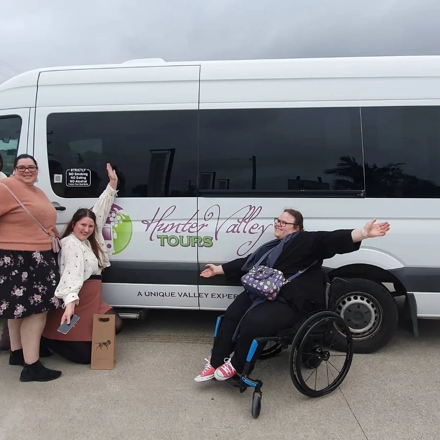 Guests wave beside the branded Hunter Valley Tours van, ready to roll
