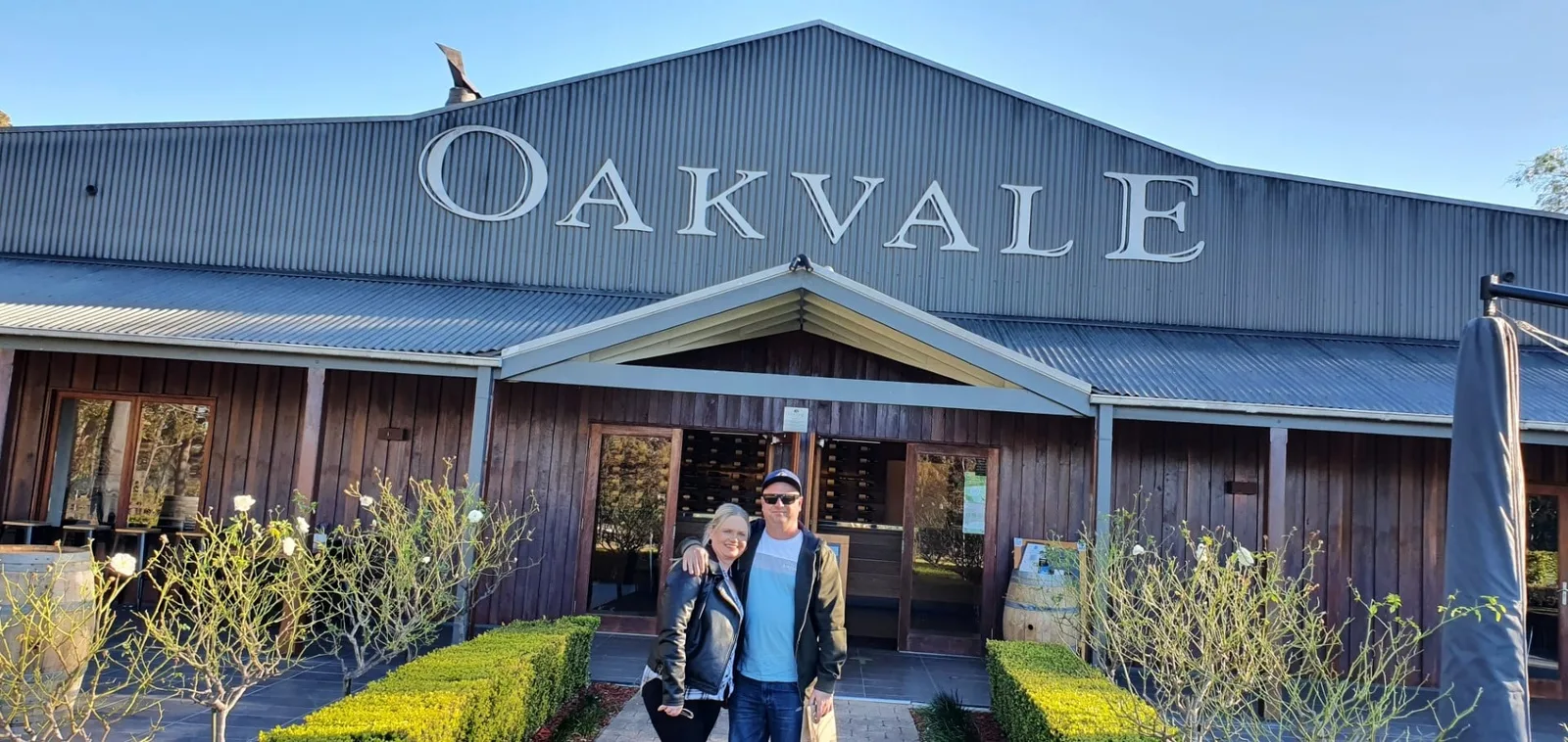 A couple stands together outside the Oakvale winery on their private tour