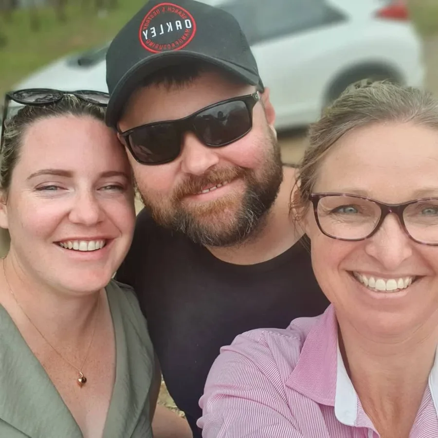Three guests lean in for a sunny selfie