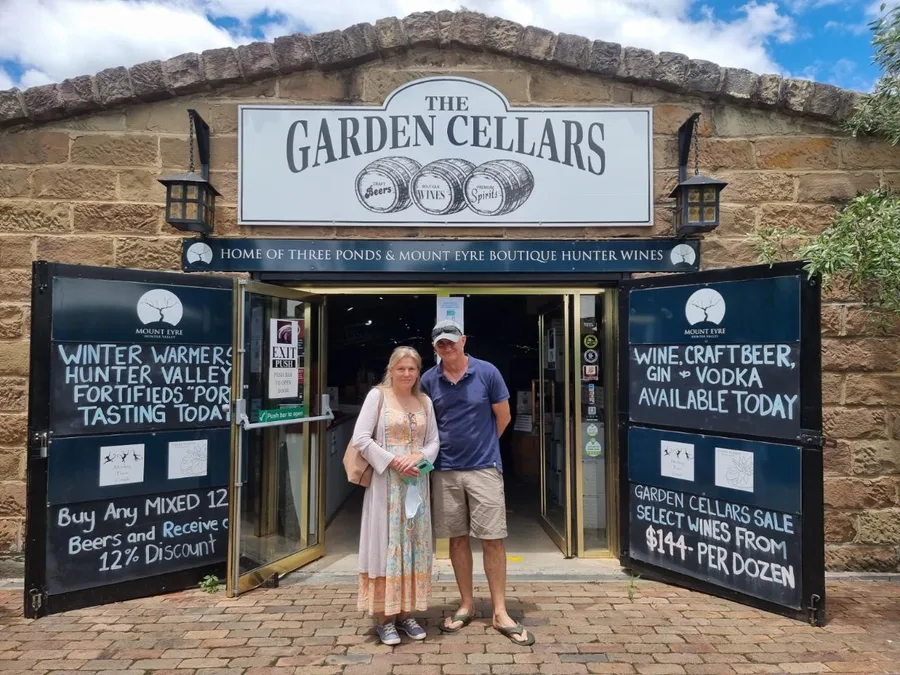 A couple outside the Garden Cellars stone entry