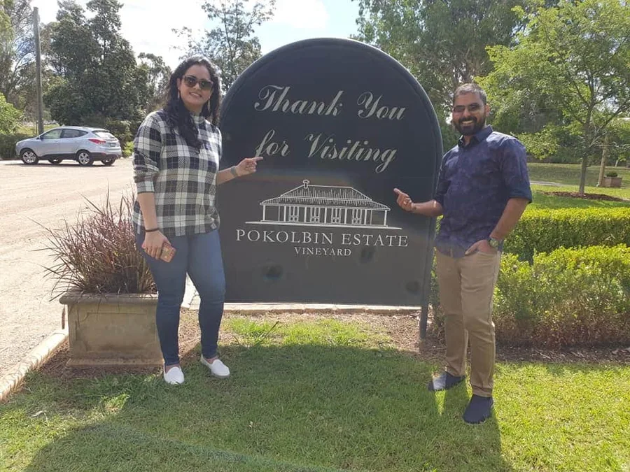 A couple at the Pokolbin Estate Vineyard sign on their Hunter Valley day tour