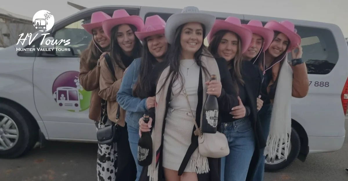 A pre-wedding crew in pink cowboy hats celebrates in front of the tour van