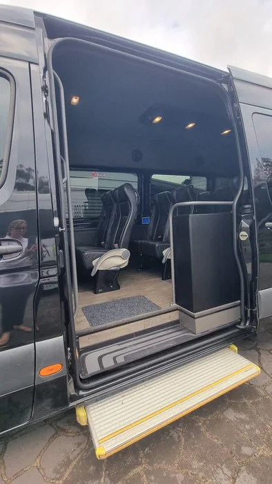 Inside the Sprinter: leather recliner seats down each side of the cabin