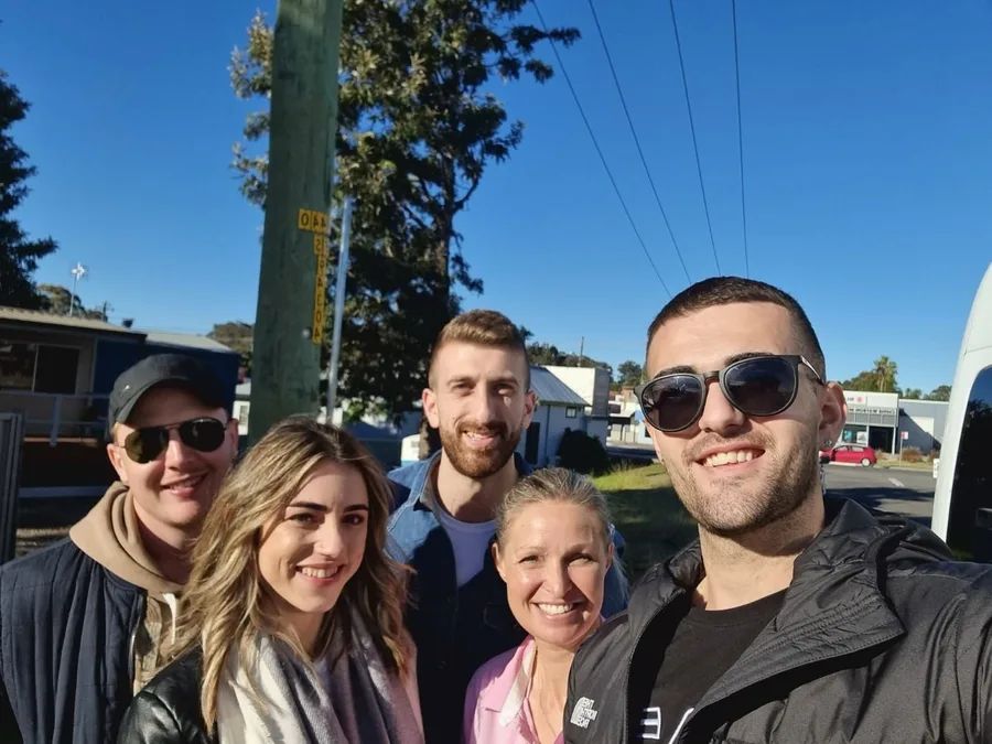 Guests and their guide grin for a group selfie on a sunny Hunter Valley tour