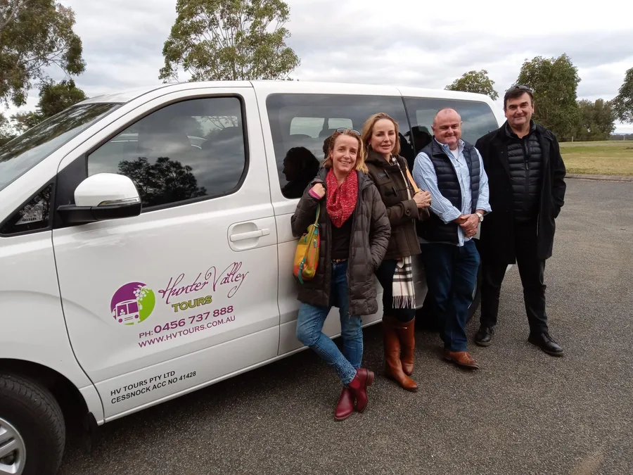 Guests beside the Hunter Valley Tours minibus, ready to leave for wine country
